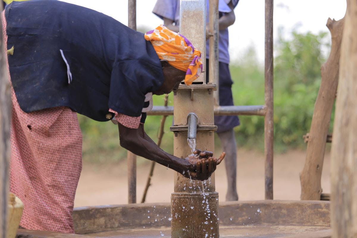 LANGO Project Woman at the borehole